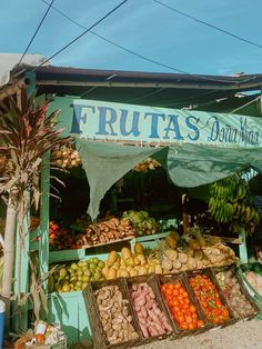 a fruit stand with lots of fruits and vegetables