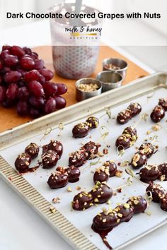 chocolate covered grapes with nuts on a tray