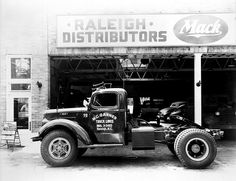 an old truck parked in front of a store