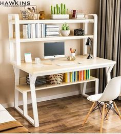 a desk with a computer and bookshelf in the corner