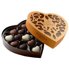 an open heart shaped box filled with chocolates