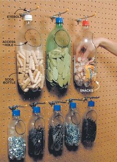 several bottles filled with different types of beads and other items on a pegboard in a store