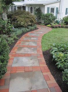 a brick walkway in front of a house