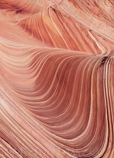 an abstract image of red rock formations with wavy lines in the middle and one at the top