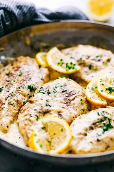 chicken with lemons and herbs in a skillet