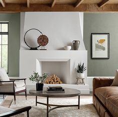 a living room filled with furniture and a fire place in the middle of a room