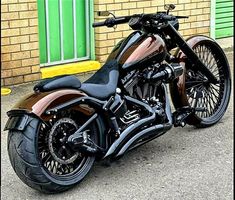 a black and brown motorcycle parked in front of a building