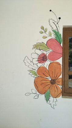 a painted flower on the side of a wall next to a window with a mirror