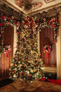 a decorated christmas tree in the corner of a room