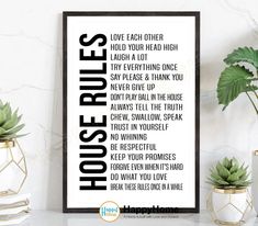 a black and white poster with the words house rules on it next to potted plants