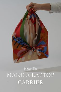 a person holding up a paper bag with the words how to make a laptop carrier