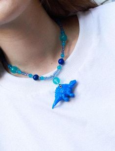 🦖 Dinosaur-Themed Statement Necklace - Unleash Your Inner Dino-Lover! These quirky dinosaur necklaces are the perfect choice for those who love bold, playful, and eco-friendly fashion. Each piece features an upcycled toy dinosaur, adding a touch of nostalgia and a unique, eye-catching charm. Ideal for anyone looking to stand out and make a statement, these necklaces bring a pop of color and personality to any outfit! ✨ Features: - Upcycled Toy Charm: Each necklace includes a toy dinosaur that's been given a second life, making it a sustainable and stylish choice. - Materials: Matte plastic beads for a soft, playful look, combined with glossy glass beads that add a hint of shine and contrast. - Stainless Steel Findings: Durable, tarnish-resistant hardware ensures your necklace stays lookin Dinosaur Necklaces, Dinosaur Necklace, Eco Friendly Fashion, Plastic Beads, Jurassic Park, Multiple Color, Second Life, Charm Necklaces, Charm Necklace