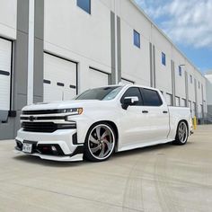 a white truck parked in front of a building