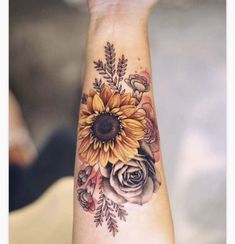 a woman's arm with a sunflower and roses tattoo on the left wrist