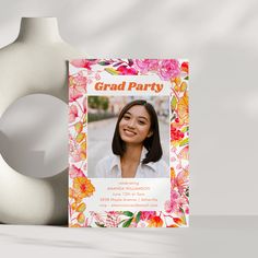 a graduation party photo with flowers on it and a vase in the background for decoration