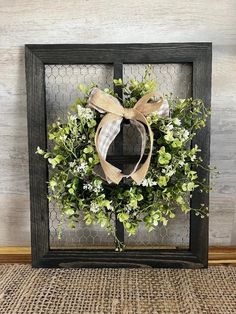 a wreath is hanging on the side of a frame