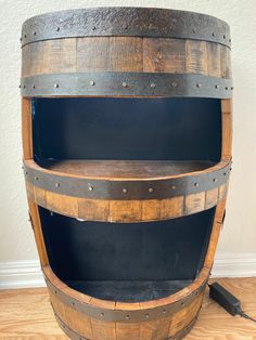 an old wooden barrel is sitting on the floor