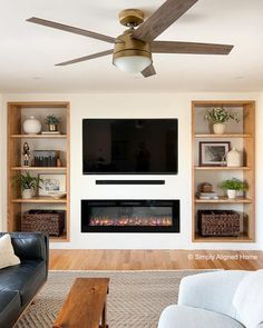 a living room with a fireplace and entertainment center