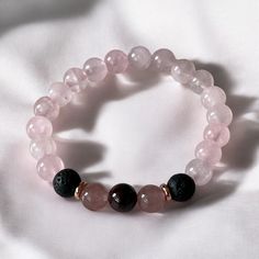 Carefully crafted and hand-strung, these bracelets feature garnet, rose quartz and strawberry quartz gemstones. They are adorned with lava beads which you can add your favourite essential oils to. Add some sparkle with your choice of 18k gold plated, rose gold plated or stainless steel pendants. SIZING Each bead is approximately 8mm. To ensure a perfect fit, please measure your wrist size with fabric tape. If you don't have fabric tape, measure with a piece of string, then measure the string and Pink Rose Quartz Natural Stone Stretch Bracelet, Pink Rose Quartz Stretch Bracelet, Hand-strung Rose Quartz Crystal Bracelet Gift, Strawberry Quartz Bracelet, Hand-strung Spiritual Rose Quartz Stretch Bracelet, Lava Bead, Strawberry Quartz, Fabric Tape, Stainless Steel Pendant