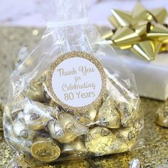 a bag full of gold foiled chocolates with a thank you for celebrating sticker