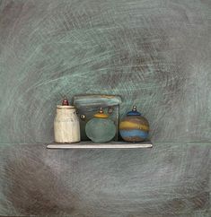 three ceramic objects are sitting on a shelf in front of a chalkboard wall that is green