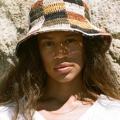 This crocheted, plant-dyed checkered bucket hat is an exclusive design for this Fall. Made by hand from naturally-dyed, cabuya plant fiber. A cute, packable hat made by hand and in small batches by our talented women artisan group. In Stock & Shipping Now. Our hats are handmade and one-of-a-kind. This means that no two are exactly alike and almost all contain irregularities from size to color. Please allow for slight imperfections as this is what adds to the unique character of each hat. Style N Brown Handwoven Crochet Hat With Short Brim, Bohemian Short Brim Crochet Hat, Bohemian Handwoven Crochet Hat With Short Brim, Casual Multicolor Handwoven Crochet Hat, Bohemian Bucket Hat With Handwoven Curved Brim, Bohemian Handwoven Bucket Hat With Curved Brim, Handwoven Brimmed Brown Crochet Hat, Brimmed Brown Handwoven Crochet Hat, Handmade Brown Bohemian Bucket Hat