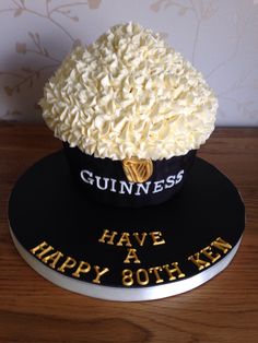 there is a cake with white frosting on it that says guinness have happy 30th