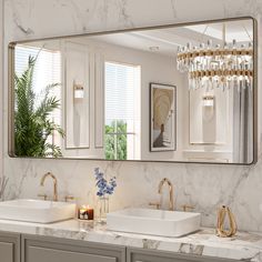 a bathroom with two sinks and a large mirror over it's counter top,