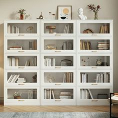 a white bookcase filled with lots of books