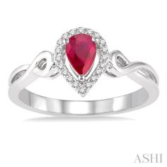 a white gold ring with a heart shaped ruby stone and diamonds on the band, set in