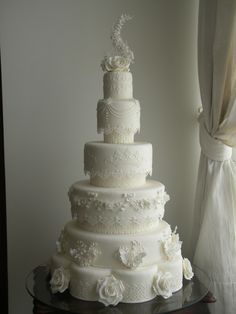 a large white wedding cake sitting on top of a table