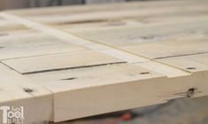 a close up view of the top of a table made out of wooden planks