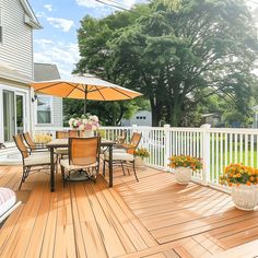 a deck with chairs and an umbrella on it