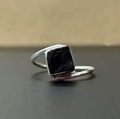 Twisted Black Tourmaline Ring, Raw Tourmaline Ring, Black Tourmaline Ring For Women, Natural Rough Stone, Handmade Ring, Gift For Her Offer Black Friday Christmas Halloween The stunning stone is the Natural Black Tourmaline Product Description : - Gemstone :- Natural Black Tourmaline Stone Color :- Black Stone Shape :- Square Stone Category :- Raw Stone Polish : High Metal :- 925 Sterling Silver Purity :- 925 Parts Per 1000 Plated :- Pure Silver Silver Polish :- High SKU# : JTGSR266 <> It is known to cleanse and purify one's aura, dispelling negative energies and thoughts. Black Tourmaline is particularly beneficial for those who work or live in challenging environments, as it helps absorb electromagnetic radiation and pollutants. Item Made With Pure 925 Sterling Silver and Nickel, Cadmium Black Tourmaline Rings As Gifts, Black Tourmaline Rings For Gift, Black Tourmaline Gemstone Rings, Raw Tourmaline Ring, Black Tourmaline Stone, Black Tourmaline Ring, Raw Tourmaline, Black Friday Christmas, Square Stone