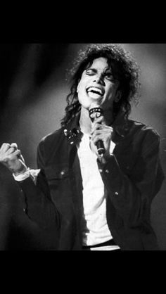 michael jackson singing into a microphone on stage