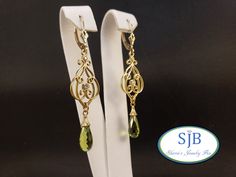 "💚 Peridot & 💎 Drop Earrings 💚 Featuring a beautiful matching pair of Bright Green Peridot briolette Gemstones. Set in all 14k Yellow Gold. Shiny bell caps, with scallop-edged decorative details hanging from large symeterical filigree dangles with bezel set Sparkling Genuine Diamond accents dropping from Classic fleur-de-lis leverbacks. Measuring in at approximately 2\" long, these amazing vintage inspired Genuine Gemstone Earrings are a treasure for any Jewelry collection. **Peridot is an of Elegant Pierced Peridot Jewelry, Elegant Peridot Earrings For Anniversary, Elegant Peridot Earrings For May Birthstone, Elegant Peridot Earrings For Wedding, Elegant Peridot Earrings, Peridot Dangle Earrings, Peridot Earrings, Peridot Gemstone, Green Peridot