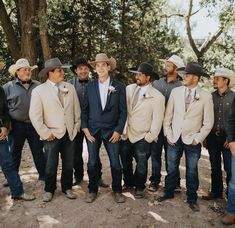 a group of men standing next to each other wearing cowboy hats and ties on their heads