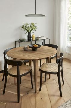 a dining room table with four chairs around it