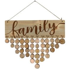 a wooden sign that says family hanging from a string with lots of circles on it