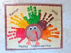 a turkey handprinted on a tile wall with the words happy thanksgiving written in it