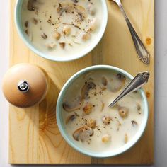 two bowls filled with soup next to an egg