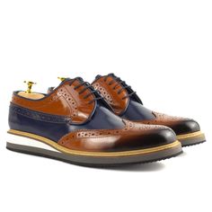 Upgrade your formal ensemble with the refined elegance of Vestito Brown-Navy Blue Leather shoes, a striking example of men's derby dress shoes. These exquisite Brown-Navy Blue Men's Leather shoes effortlessly combine sophistication and style, making a distinct mark on any occasion. Crafted with meticulous attention to detail, these high-quality shoes are designed to stand apart, offering the perfect blend of class and individuality. Elevate your fashion game and embrace the allure of Vestito Bro Blue Wingtip Monk Strap Business Shoes, Blue Wingtip Monk Strap Shoes For Business, Blue Monk Strap Shoes With Brogue Detailing For Business, Blue Wingtip Dress Shoes With Brogue Detailing, Blue Oxford Dress Shoes With Brogue Detailing, Formal Blue Monk Strap Shoes With Rubber Sole, Blue Brogue Dress Shoes, Blue Plain Toe Oxfords For Business, Blue Oxfords With Brogue Detailing