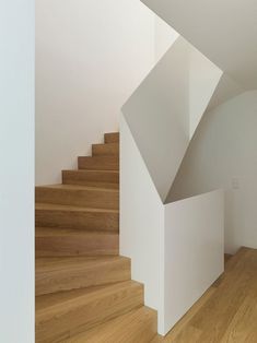 an empty room with wood floors and white walls is seen from the bottom, looking down