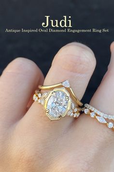 a woman's hand with two gold rings on top of her finger and the other ring