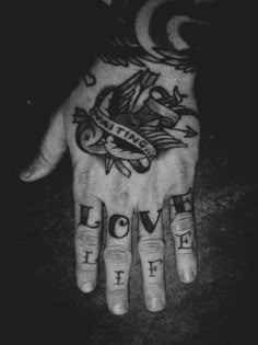 a person's hand with tattoos on it and the words love life written in different languages