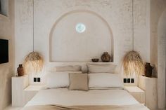 a bed with white linens and pillows in a room that looks like an arch