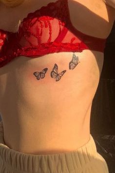 a woman wearing a bra with butterflies on her stomach