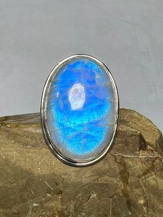 Rainbow Moonstone Ring, Sterling Silver Ring, 23x34 MM Oval Rainbow Moonstone Ring, Women Ring, Natural Moonstone Ring, Blue Fire Ring B 228 Item details Handmade Material Silver, Stone Metal -- 92.5 Sterling Silver Stone -- Natural Rainbow Moonstone  Stone Size -- 23x34 MM Weight -- 16.05 gm  Stone Shape -- Oval LARGE COCKTAIL RING Rainbow Moonstone Ring  LARGE RING  Rainbow Moonstone is set in Sterling silver ABOUT (Rainbow moonstone is thought to bring balance, harmony and hope while enhancing creativity, compassion, endurance and inner confidence. Rainbow moonstone is believed to help strengthen intuition and psychic perception, especially offering us visions of things that aren't immediately obvious) (Rainbow moonstone is associated with various Moon Goddesses .Moonstone has a very st Fire Ring, Moonstone Ring Sterling Silver, Moonstone Stone, Rainbow Moonstone Ring, Sterling Silver Jewelry Handmade, Silver Gemstone Jewelry, Jewelry Manufacturers, Moonstone Ring, Rainbow Moonstone