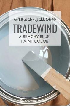 a paint can with the words shewn williams tradewind on it and a wooden spatula