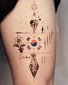 a woman's thigh with an abstract tattoo design on the back of her leg